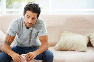 Man sits on couch and ponders how long does codeine stay in your system