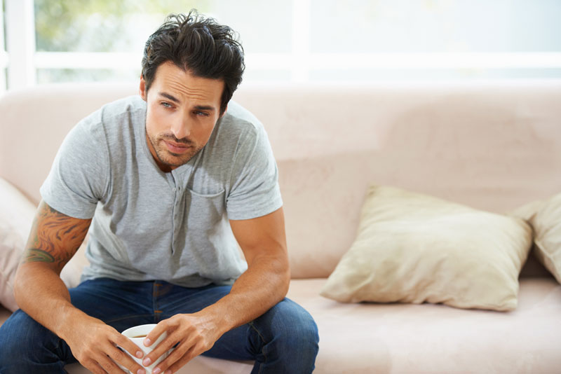 Man sits on couch and ponders how long does codeine stay in your system