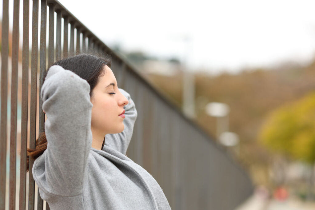 Woman leans against wall during first few days sober