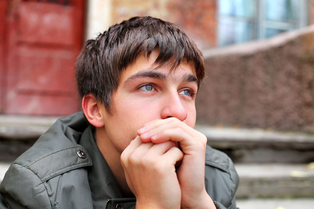 Man sits on stoop and wonders how long does it take to detox