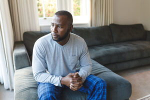 Man sits on couch and ponders combined drug intoxication