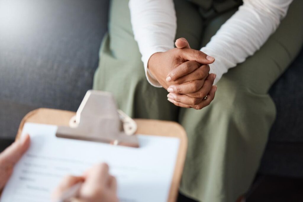 Therapist takes notes while telling girl how EMDR for OCD works