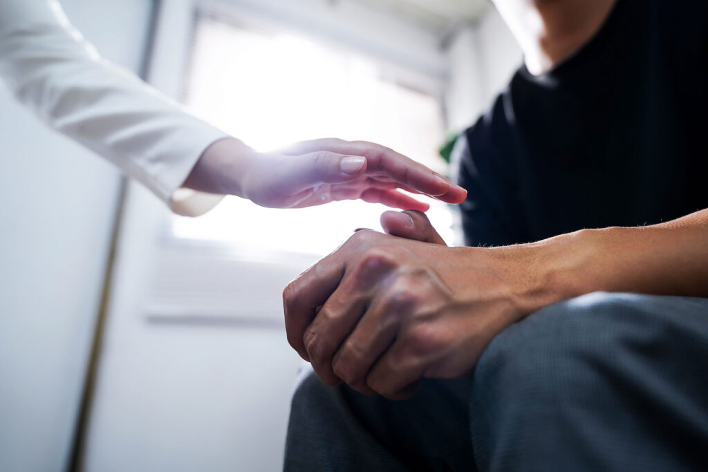 Woman comforts friend after learning some tips to support someone in recovery